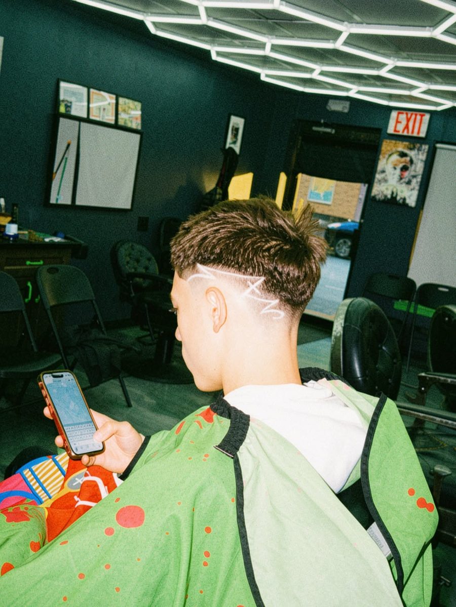 Back view of a skin fade with a lined design cut in