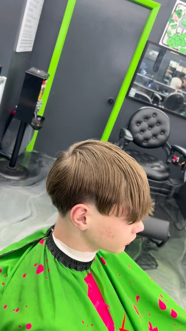 Young client with a straight fringe and a low taper